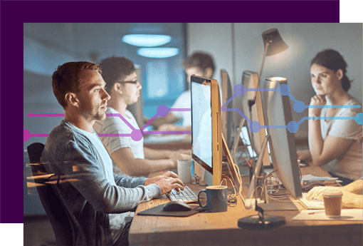 Shot of a group of young people using computers during a late night in a modern office