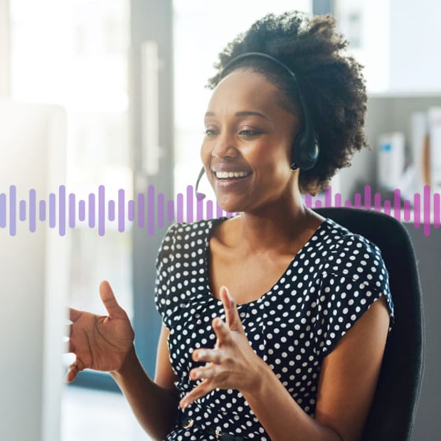 SEO UC SIP Phone Blog Header Photo of a smiling agent sitting at her computer talking to a customer through her headset. A series of small vertical lines representing sound run across the frame.
