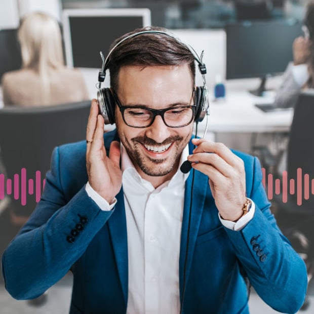UC IP Phone Systems Blog Header Photo of smiling employee talking on his headset to a customer or colleague.