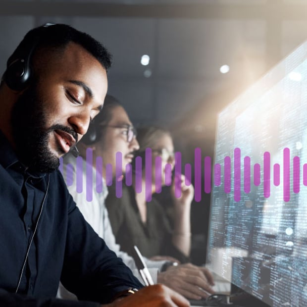 VBC Integrations Superpowers blog Man wearing a headset working in front of a computer screen displaying data, as a man and woman colleague work in the background.