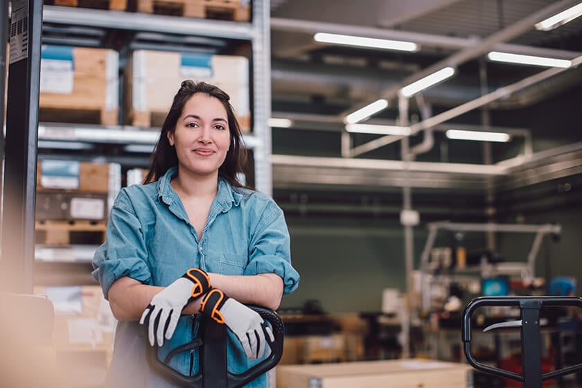 woman wearing gloves in warehouse