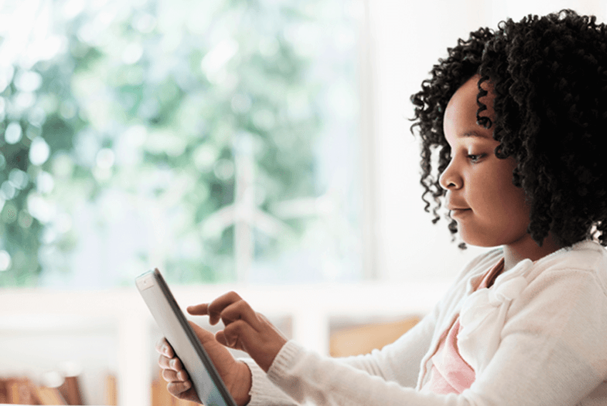 young girl using a tablet at home