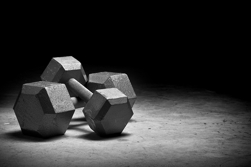 Weight lifting Dumbbells isolated on grunge surface.